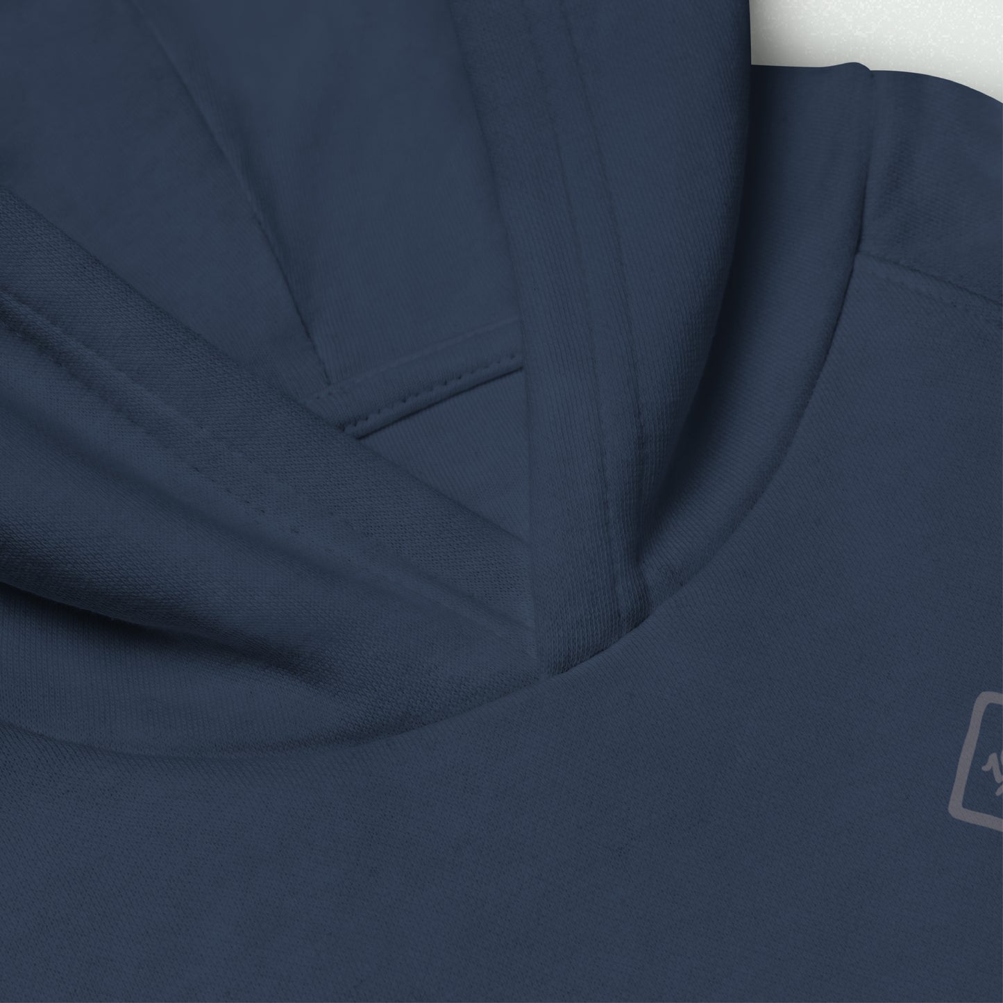 Close-up view of the 100yrs Logo Unisex Kids Eco Hoodie in navy blue, showcasing the soft texture and jersey-lined hood for added warmth.