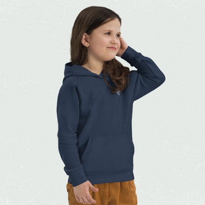 Young child wearing a navy blue "Unisex Kids Eco Hoodie" featuring a small logo on the chest, with hands in front pocket and a relaxed expression.