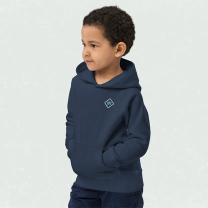 Kid wearing a navy blue unisex eco hoodie with the "100yrs" logo, hands tucked into the front pouch pocket, looking to the side.