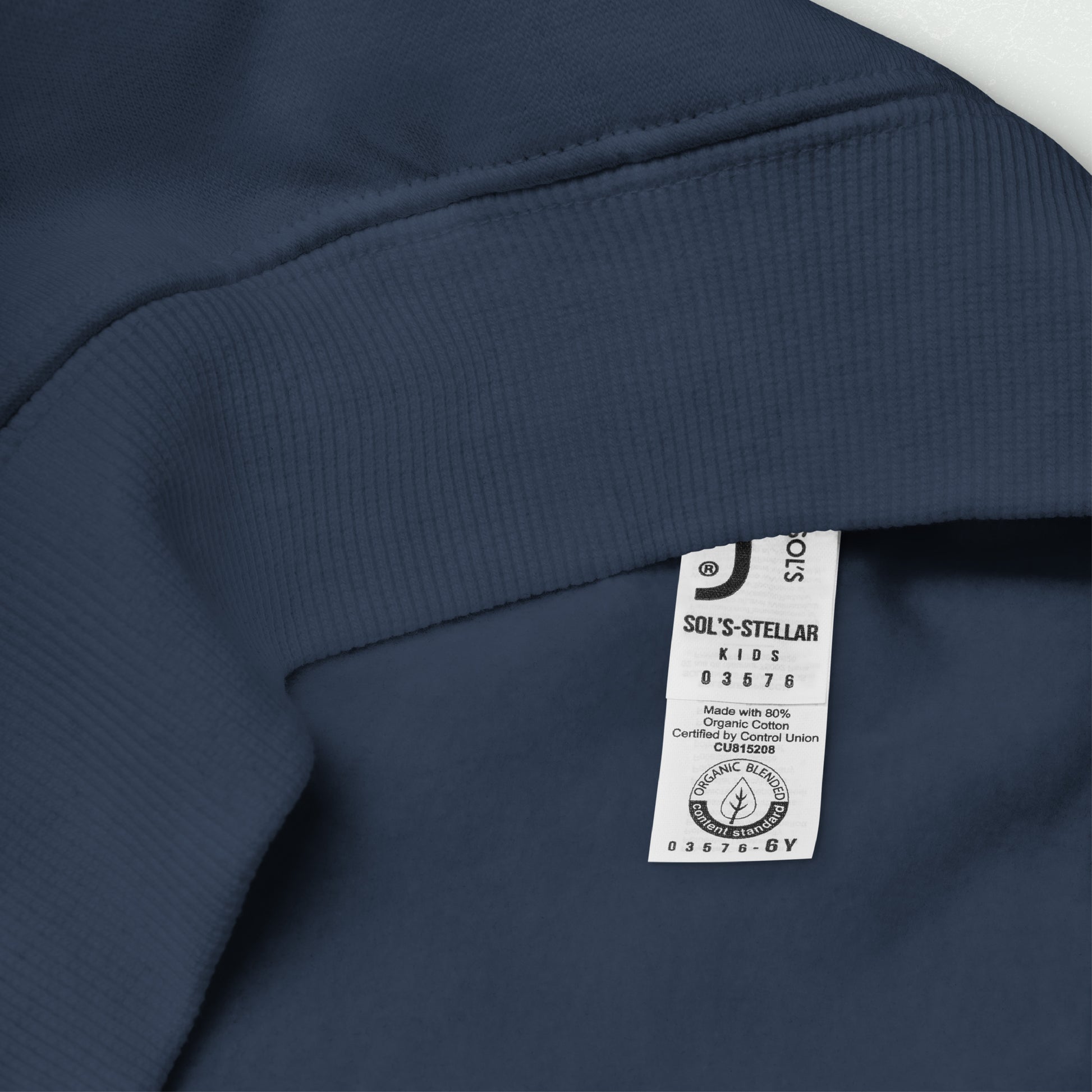 Close-up of the inner fabric and care label of the Unisex Kids Eco Hoodie in navy blue, showcasing the organic cotton and recycled polyester blend.